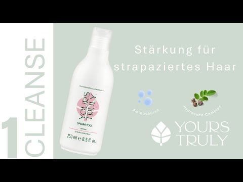 weiße-shampooflasche-yours-truly-repair-mit-aufdruck-strukturaufbau-daneben-text-stärkung-für-strapaziertes-haar-und-abbildungen-von-aminosäuren-und-pflanzensamen-verlinkung-zu-youtube-video
